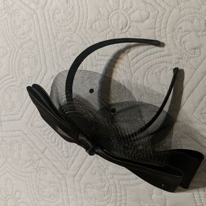 Black fascinator with large bow and black dotted netting